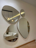 Modern interior design with circular mirrors on a wall, reflecting a living room.