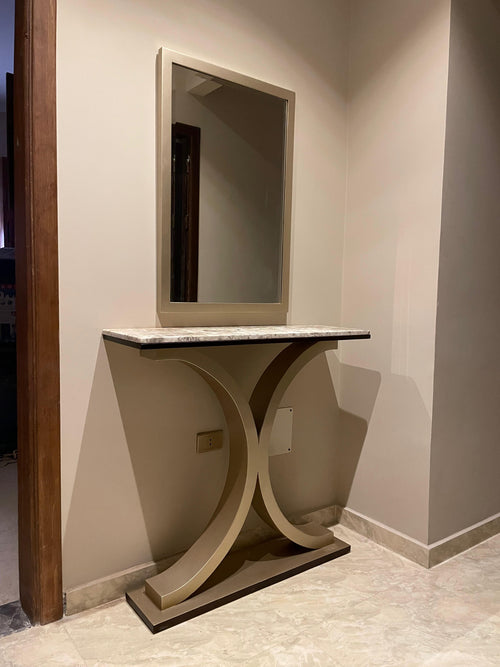 Modern console table with marble top against a wall