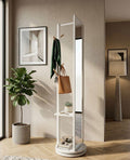 White freestanding mirror with shelves in a room with a plant and framed picture.