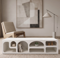 Modern living room with a concrete coffee table, chair, and abstract art.