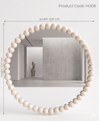 Round mirror with a bead-like frame on a white wall, dimensions indicated.